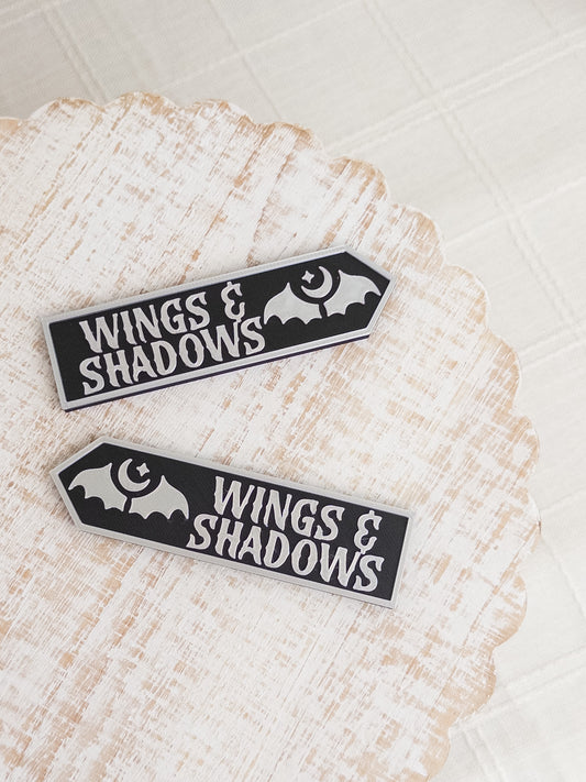 Wings & Shadows Sign